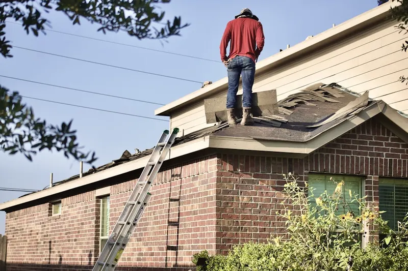 Professional roofer working on a residential roof in Ackerson